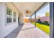 Outdoor covered patio with fans overlooking the artificial turf lawn and block wall at 9057 N Skye Treeline St, Las Vegas, NV 89166