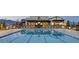 Community swimming pool with lounge chairs surrounded by fence, offering a refreshing oasis for residents at 9057 N Skye Treeline St, Las Vegas, NV 89166