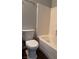 A bathroom with a toilet and tiled bathtub and shower combination at 9303 Gilcrease Ave # 1097, Las Vegas, NV 89149