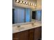 Bathroom features a double sink vanity with large mirrors and good lighting at 9303 Gilcrease Ave # 1097, Las Vegas, NV 89149