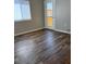 Bedroom featuring durable wood-look floors and a bright sliding door at 9303 Gilcrease Ave # 1097, Las Vegas, NV 89149