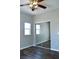 A cozy bedroom showcasing mirrored closet doors, wood-look flooring, and a ceiling fan at 9303 Gilcrease Ave # 1097, Las Vegas, NV 89149