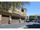 Exterior shot of the residential building with several garages and cars at 9303 Gilcrease Ave # 1097, Las Vegas, NV 89149