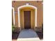 Inviting front door with a charming arched entrance and stylish stacked stone accents at 9303 Gilcrease Ave # 1097, Las Vegas, NV 89149