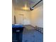 The garage showcasing an open garage door and items stored on the garage floor at 9303 Gilcrease Ave # 1097, Las Vegas, NV 89149