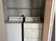Bright laundry room with white washer and dryer, features wire shelving for storage at 9303 Gilcrease Ave # 1097, Las Vegas, NV 89149