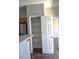 Walk-in pantry with wood shelving behind a six-panel door at 9303 Gilcrease Ave # 1097, Las Vegas, NV 89149
