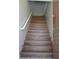 View of a home's staircase with wood-look treads and a white handrail at 9303 Gilcrease Ave # 1097, Las Vegas, NV 89149