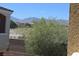 Serene view of mountains, desert landscape, and neighborhood homes through the backyard foliage at 9303 Gilcrease Ave # 1097, Las Vegas, NV 89149