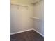 A walk-in closet featuring white wire shelving units and neutral-colored walls and carpeting at 9303 Gilcrease Ave # 1097, Las Vegas, NV 89149