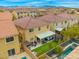 High angle view of the home's backyard featuring a patio, grill area, and hot tub with pool nearby at 9768 Fox Estate St, Las Vegas, NV 89141