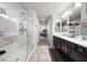 This full bathroom has a double vanity, shower, bath, and leads to a connecting bedroom at 9768 Fox Estate St, Las Vegas, NV 89141