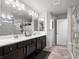 This bathroom has a double vanity, shower, bath, and plenty of storage space at 9768 Fox Estate St, Las Vegas, NV 89141