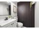 Half bathroom with modern vanity, stylish decor, and a dark shiplap accent wall at 9768 Fox Estate St, Las Vegas, NV 89141