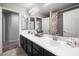 This bathroom features a double vanity with ample storage, and updated plumbing at 9768 Fox Estate St, Las Vegas, NV 89141