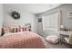 This bedroom has carpet, a colorful bed, and a light-filled window to provide ample light at 9768 Fox Estate St, Las Vegas, NV 89141