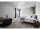 This bedroom has carpet, a desk, and a large window that provides natural light at 9768 Fox Estate St, Las Vegas, NV 89141