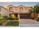 Beautiful two-story home features a paver driveway, manicured landscaping, and a spacious two car garage at 9768 Fox Estate St, Las Vegas, NV 89141