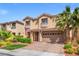 Inviting two-story home with a manicured lawn, paver driveway, and a two-car garage at 9768 Fox Estate St, Las Vegas, NV 89141
