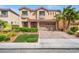 Charming two-story home with a paver driveway, landscaped front yard, and attached garage at 9768 Fox Estate St, Las Vegas, NV 89141