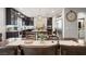 An open-concept kitchen featuring dark cabinets, stainless steel appliances, and a large center island at 9768 Fox Estate St, Las Vegas, NV 89141