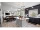 Open kitchen showcases stainless steel appliances, island, and is open to dining and living areas at 9768 Fox Estate St, Las Vegas, NV 89141
