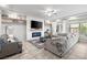 Comfortable living space with modern fireplace, plush seating, decorative shelving, and large windows at 9768 Fox Estate St, Las Vegas, NV 89141