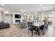 Open-concept living room with fireplace, built-in shelves, and dining area with backyard view at 9768 Fox Estate St, Las Vegas, NV 89141