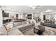 Open-concept living room with comfortable seating, stylish decor, and easy access to the kitchen and game room at 9768 Fox Estate St, Las Vegas, NV 89141
