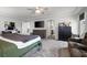 Spacious main bedroom with a ceiling fan, dresser, bed, and a seating area at 9768 Fox Estate St, Las Vegas, NV 89141