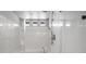 This shower features new plumbing, marble-look paneling, and natural light at 9768 Fox Estate St, Las Vegas, NV 89141