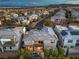 Elevated view of residential homes, featuring solar panels and private pools, nestled against a backdrop of hills at 10 Sugarberry Ln, Las Vegas, NV 89135