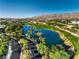 Aerial view of the community showcasing a lake, golf course, and luxury homes at 10 Sugarberry Ln, Las Vegas, NV 89135