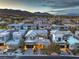 Expansive aerial view of a luxury home at dusk, showcasing a well-lit modern design in a vibrant community at 10 Sugarberry Ln, Las Vegas, NV 89135