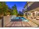 Expansive backyard with a modern pool, spa, and landscaped surroundings, ideal for outdoor enjoyment and relaxation at 10 Sugarberry Ln, Las Vegas, NV 89135