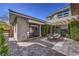 Well-designed backyard with a covered patio, dining area, and landscaped greenery at 10 Sugarberry Ln, Las Vegas, NV 89135