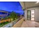 A balcony provides outdoor space with privacy landscaping, adjacent to interior living area at 10 Sugarberry Ln, Las Vegas, NV 89135
