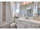 Bathroom featuring a shower-tub combo, white vanity, and decorative accents at 10 Sugarberry Ln, Las Vegas, NV 89135