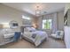 Comfortable bedroom with a desk and sitting area, featuring modern decor and ample light at 10 Sugarberry Ln, Las Vegas, NV 89135
