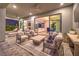 Comfortable outdoor seating area on a covered patio, offering a view into the modern home interior at 10 Sugarberry Ln, Las Vegas, NV 89135