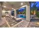 Elegant covered patio with comfortable lounge furniture, a view of the pool, and outdoor ceiling fans at 10 Sugarberry Ln, Las Vegas, NV 89135