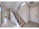 Entryway featuring a staircase with metal railings, large windows and tile flooring at 10 Sugarberry Ln, Las Vegas, NV 89135