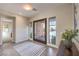 Bright foyer features a modern front door, large windows, neutral walls, and stylish tile flooring at 10 Sugarberry Ln, Las Vegas, NV 89135