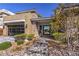 Stunning front exterior showcases modern design, beautiful landscaping, and a garage with glass door at 10 Sugarberry Ln, Las Vegas, NV 89135