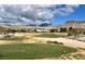 View of the golf course with mountains in the background, nestled among desert landscaping and custom homes at 10 Sugarberry Ln, Las Vegas, NV 89135