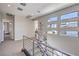 Bright hallway with sleek metal railings, modern windows and plush neutral carpet at 10 Sugarberry Ln, Las Vegas, NV 89135