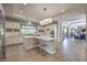 Modern kitchen with white cabinets, large island, stylish backsplash, and stainless steel appliances at 10 Sugarberry Ln, Las Vegas, NV 89135