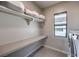 Laundry room with long white countertop, window, overhead rack and a washer dryer at 10 Sugarberry Ln, Las Vegas, NV 89135