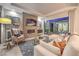 Contemporary living room with fireplace, plush seating, and access to outdoor area at 10 Sugarberry Ln, Las Vegas, NV 89135