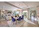 Elegant living room features dining table, fireplace, recessed ceilings, and view of the landscaped yard at 10 Sugarberry Ln, Las Vegas, NV 89135